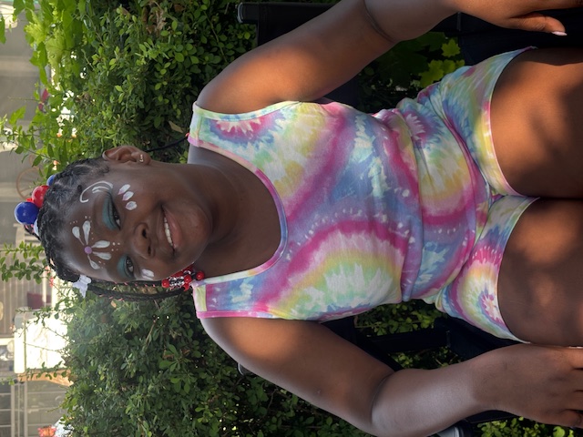 Young community member smiling at a summer event